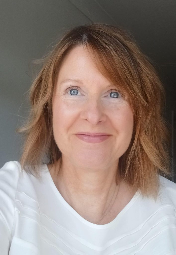 Woman in white top smiling